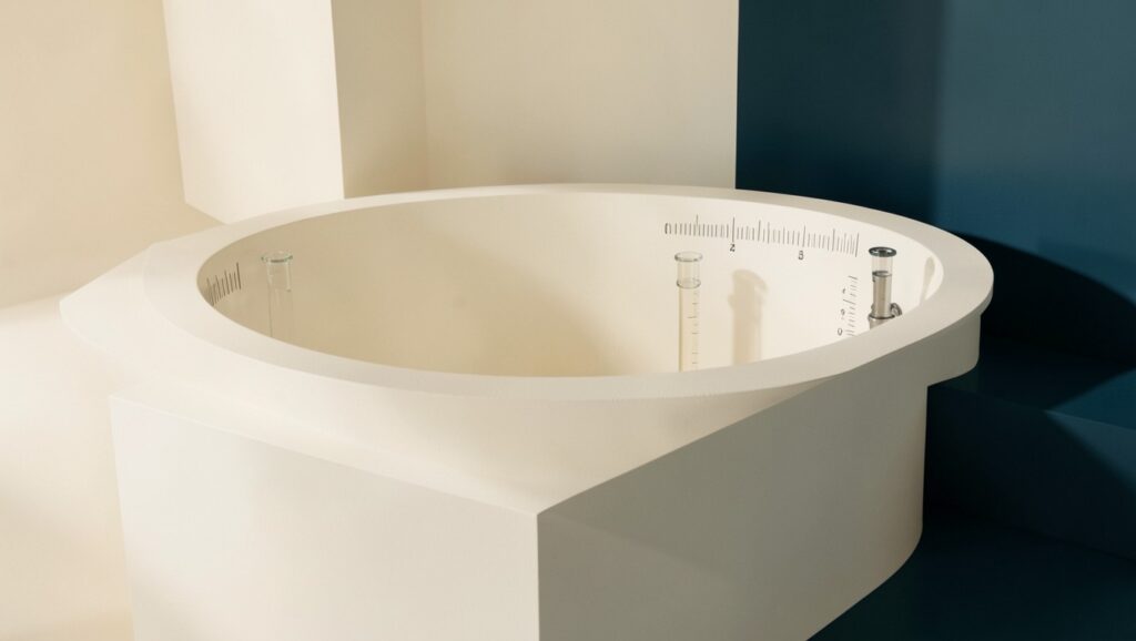 A clean architectural cistern with measured glass-tube indicators on the side.