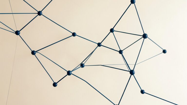 A constellation of geometric nodes connected by clean lines, evoking a knowledge graph.